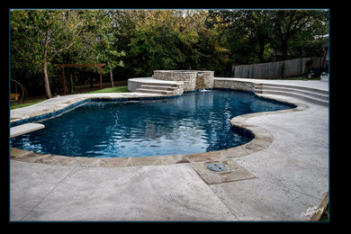 Mid-sized elegant backyard custom-shaped natural hot tub photo in Oklahoma City with decking