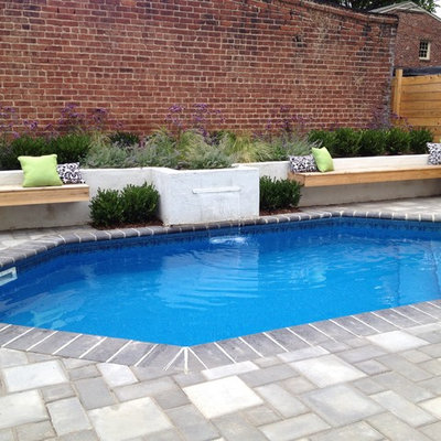 Mid-sized tuscan backyard concrete paver and custom-shaped lap pool fountain photo in Richmond