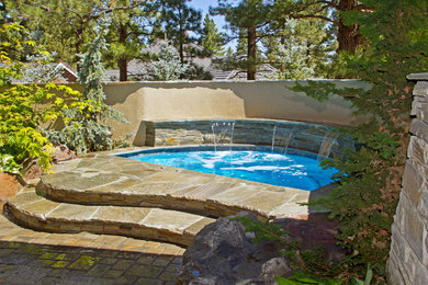 Hot tub - small traditional backyard custom-shaped natural hot tub idea in Other