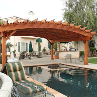 This is an example of an expansive arts and crafts backyard custom-shaped pool in San Francisco with a pool house and concrete slab.