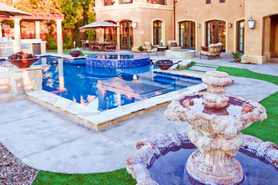 Inspiration for a mid-sized transitional backyard stone and custom-shaped natural hot tub remodel in Orange County
