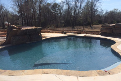 Mid-sized arts and crafts backyard custom-shaped natural pool fountain photo in Oklahoma City