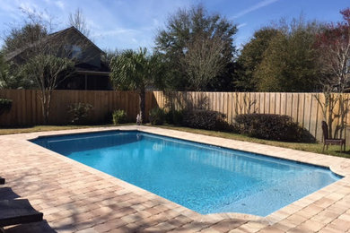 Pool - mid-sized contemporary backyard brick and rectangular natural pool idea in Jacksonville