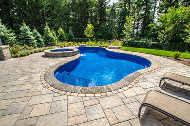 Custom curved pool with spillover hot tub - Georgetown