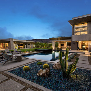 Inspiration for an expansive contemporary courtyard rectangular pool in Las Vegas with a hot tub and decomposed granite.