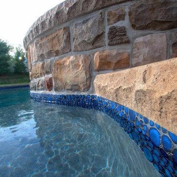 Custom Freeform salt water inground pool with raised spa