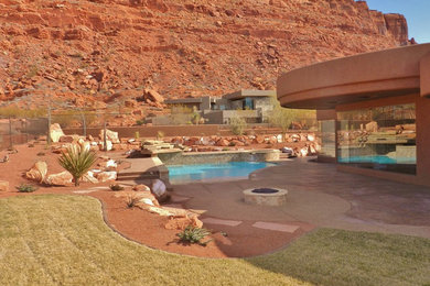 Huge backyard stone and custom-shaped lap pool fountain photo in Salt Lake City