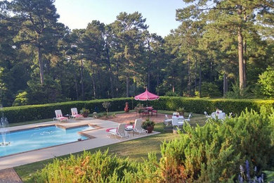 Large cottage chic backyard concrete paver and rectangular lap pool fountain photo in Atlanta