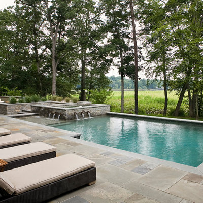 Example of a mid-sized trendy backyard tile and rectangular lap pool fountain design in Philadelphia
