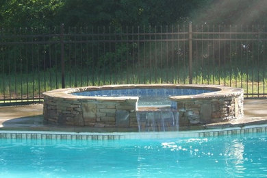 Imagen de piscinas y jacuzzis clásicos de tamaño medio a medida en patio trasero con losas de hormigón