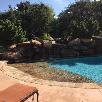 Custom Pool with Beach Entry and Large Waterfall