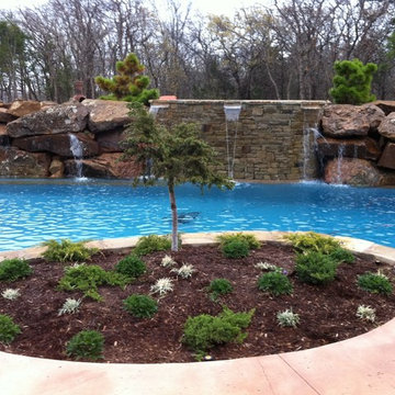Custom Pool with Beach Entry and Large Waterfall