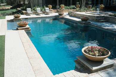 Inspiration for a large timeless backyard brick and l-shaped pool fountain remodel in Miami