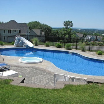 Custom pool with spillover hot tub and slide