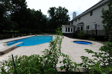 Inspiration for a large timeless backyard stone and rectangular lap hot tub remodel in Philadelphia