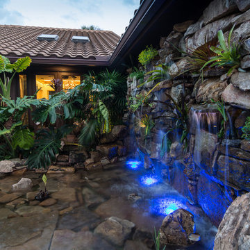 Custom Rock Waterfall Pool with Stone Grotto, Stream and Tiki Hut