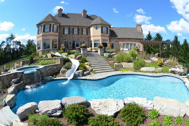 Custom Salt Water Pool with Raised Spa, Waterslide, and Outdoor Kitchen