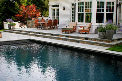 Inspiration for a huge contemporary backyard pool remodel in New York