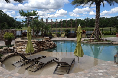 Island style pool photo in Orlando