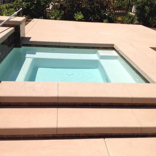 Small modern backyard custom-shaped pool in San Diego with a hot tub and concrete slab.