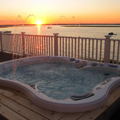 Inspiration for a contemporary backyard custom-shaped aboveground hot tub remodel in San Diego with decking