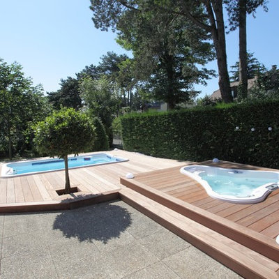 Inspiration for a large contemporary backyard custom-shaped aboveground hot tub remodel in San Diego with decking