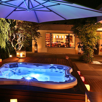 Hot tub - contemporary backyard custom-shaped aboveground hot tub idea in San Diego with decking