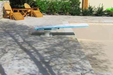 Pool - large traditional stone and rectangular lap pool idea in Other
