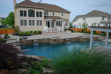 Pool fountain - mid-sized traditional backyard concrete paver and custom-shaped natural pool fountain idea in DC Metro
