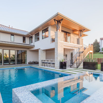 Example of a large trendy backyard concrete and rectangular hot tub design in Dallas