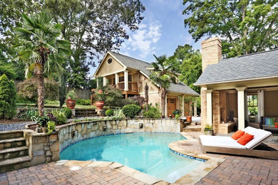 Inspiration for a large craftsman backyard brick and custom-shaped pool remodel in Atlanta
