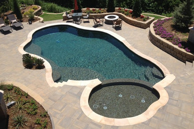 Inspiration for a large modern concrete paver and custom-shaped pool remodel in Oklahoma City