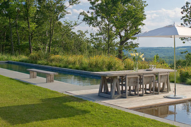 Pool - cottage backyard pool idea in New York with decking