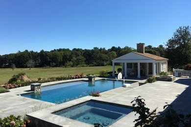 Hot tub - large contemporary backyard stamped concrete and custom-shaped natural hot tub idea in Boston