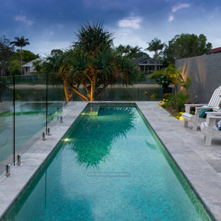 Photo of a contemporary rectangular lap pool in Other with tile.
