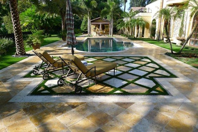 Example of a large tuscan backyard tile and custom-shaped aboveground pool house design in Orlando