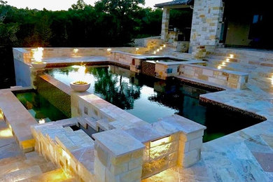 Large tuscan backyard tile and rectangular infinity hot tub photo in Austin