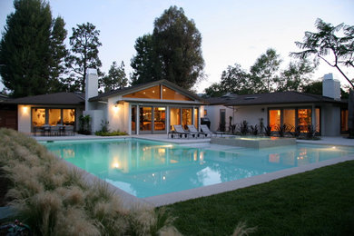 Example of a large trendy backyard l-shaped pool design in Los Angeles