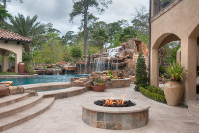 Inspiration for a huge mediterranean backyard custom-shaped and tile lap hot tub remodel in Houston