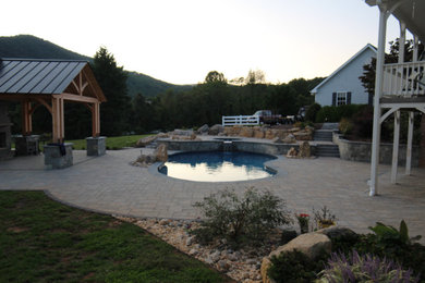 Inspiration for a mid-sized rustic backyard brick and custom-shaped natural pool landscaping remodel in DC Metro
