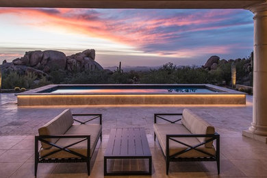 Mid-sized transitional backyard stone and rectangular lap pool photo in Phoenix