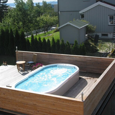 Example of a large classic side yard custom-shaped aboveground pool design in San Diego with decking