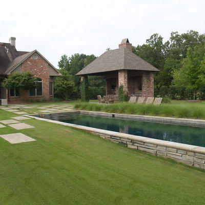 Inspiration for a large contemporary backyard stone and rectangular lap pool house remodel in New Orleans