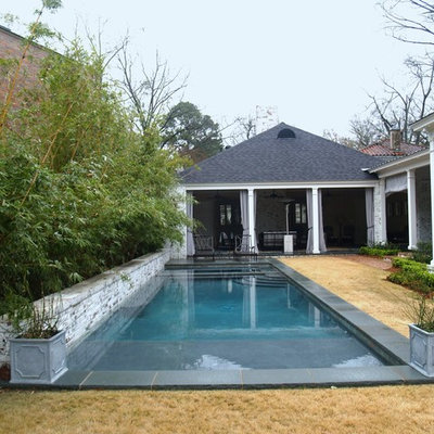 Example of a mid-sized trendy backyard stone and rectangular pool house design in New Orleans