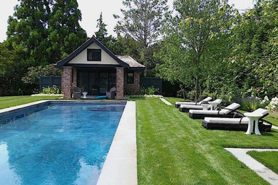 Large trendy backyard stone and custom-shaped natural pool house photo in New York