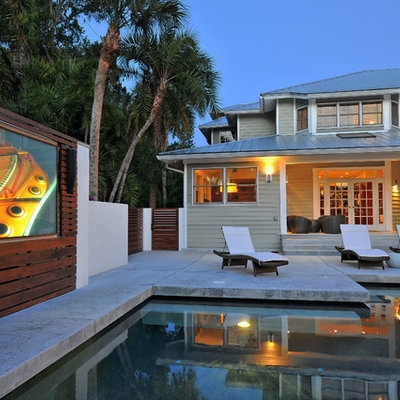 Pool house - small transitional backyard rectangular pool house idea in Tampa