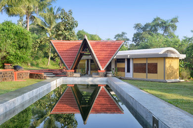 Modelo de casa de la piscina y piscina natural de estilo de casa de campo extra grande rectangular en patio delantero con adoquines de piedra natural