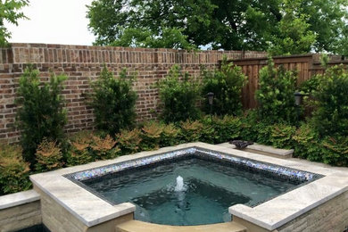 Example of a mid-sized classic backyard stone and l-shaped natural hot tub design in Dallas