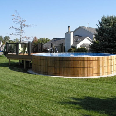 Tuscan backyard concrete aboveground pool photo in New York