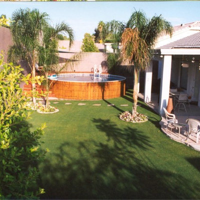 Example of a tuscan courtyard concrete paver aboveground pool design in New York